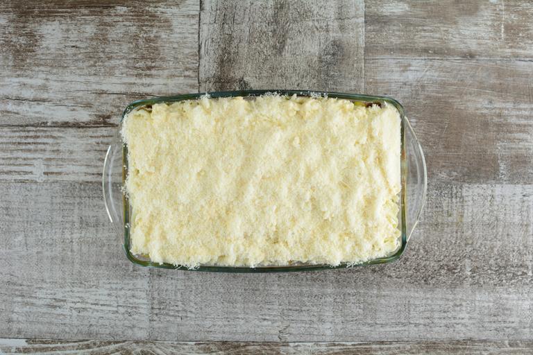 Grated parmesan is the final top of the lasagna. So it covers and hides all the layers.